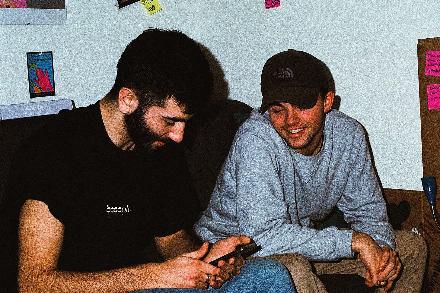 Friends look at a phone.